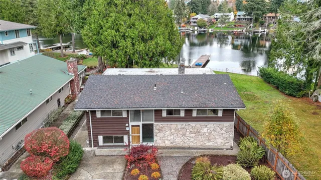 an aerial view of a house with lake view