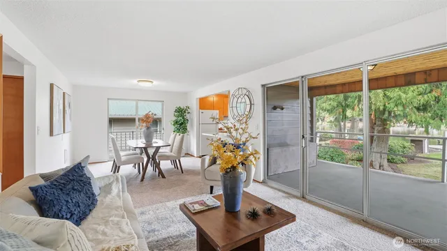 a living room with furniture and a floor to ceiling window