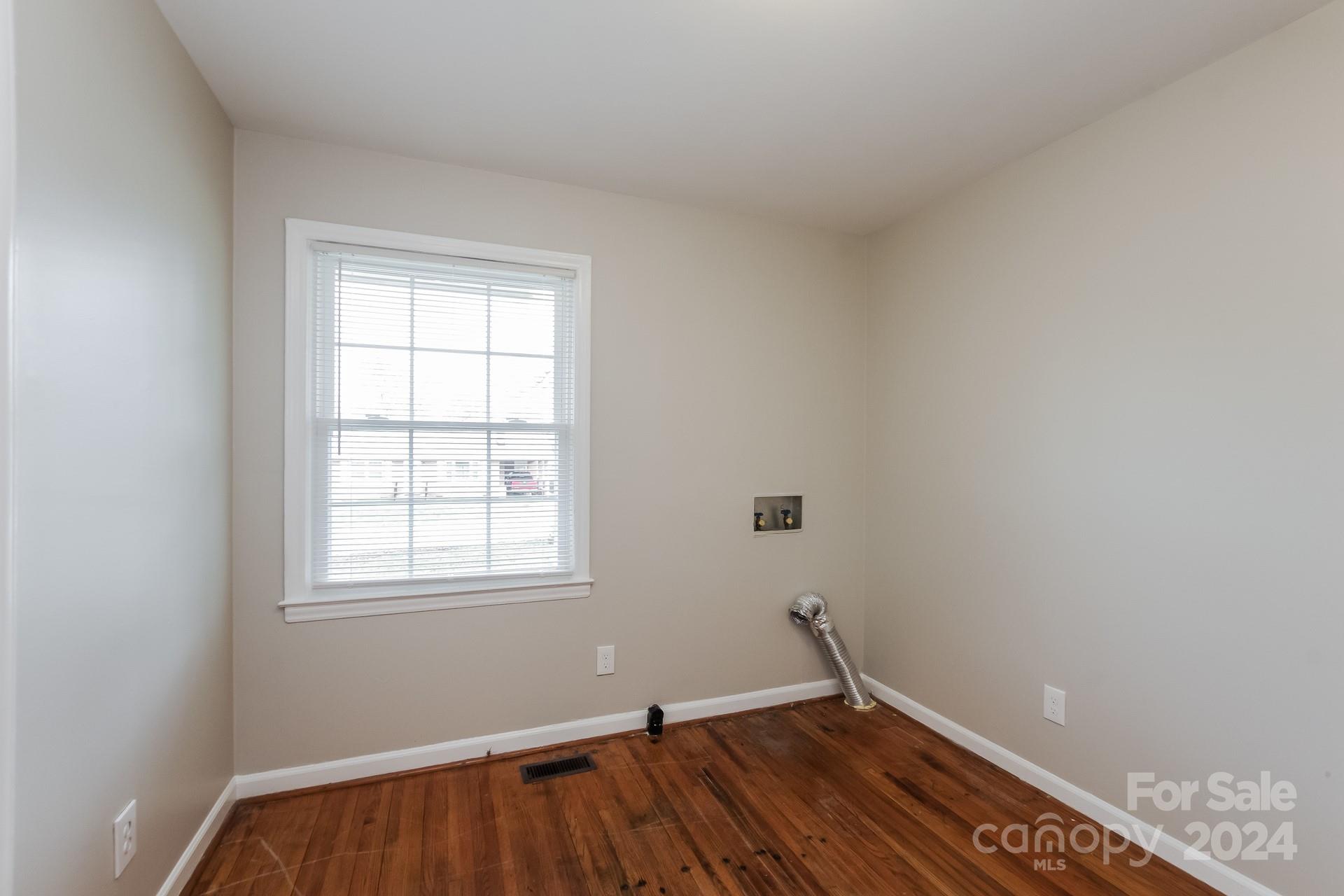 123 Boatright Road Pineville, NC 28134 - Photo 12 of 15 an empty room with wooden floor and windows