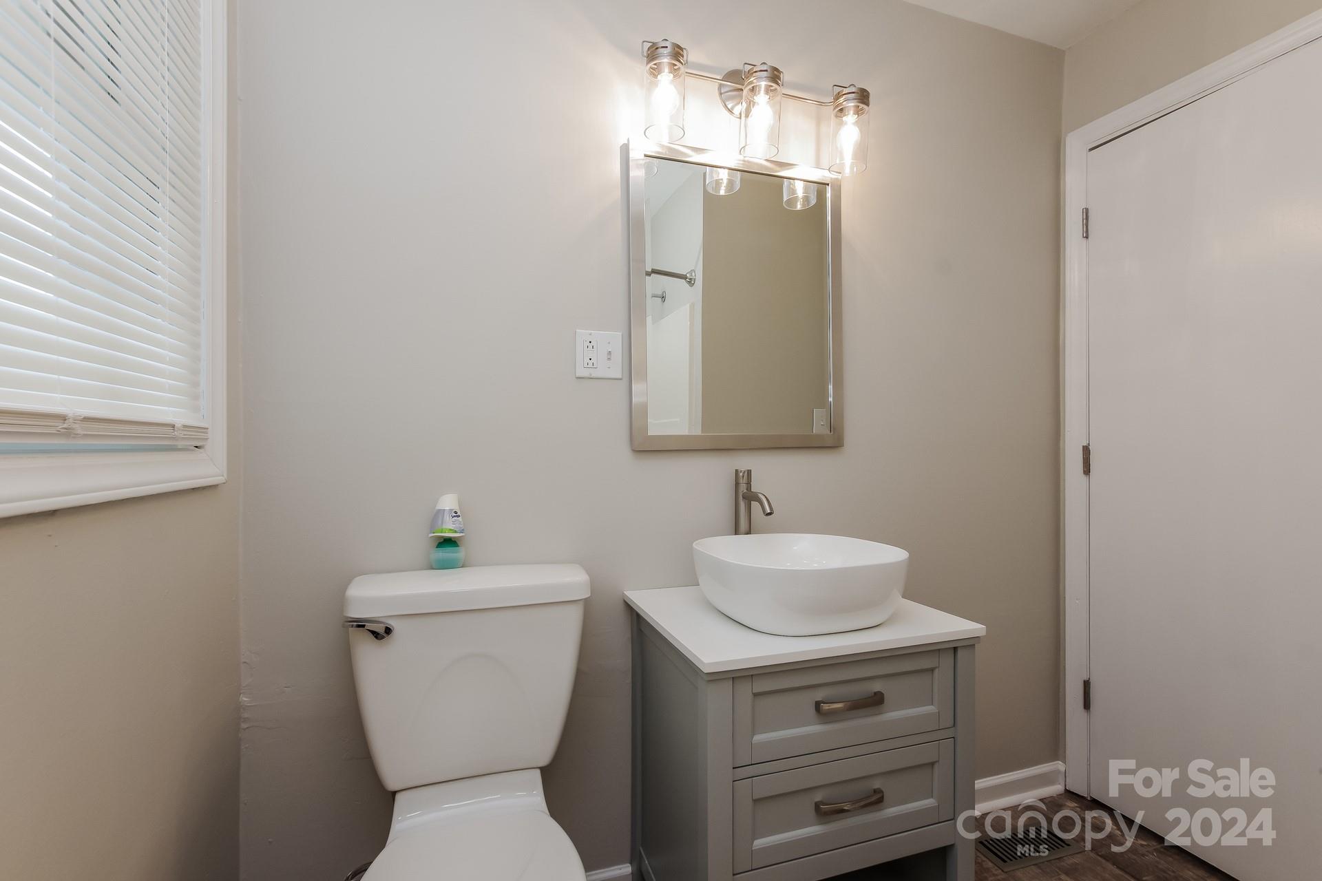 123 Boatright Road Pineville, NC 28134 - Photo 13 of 15 a bathroom with a toilet sink and mirror