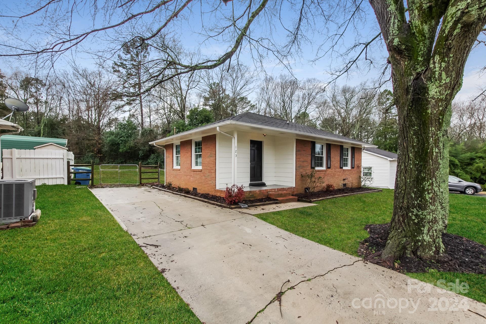 123 Boatright Road Pineville, NC 28134 - Photo 2 of 15 a view of a yard with a house and a large tree