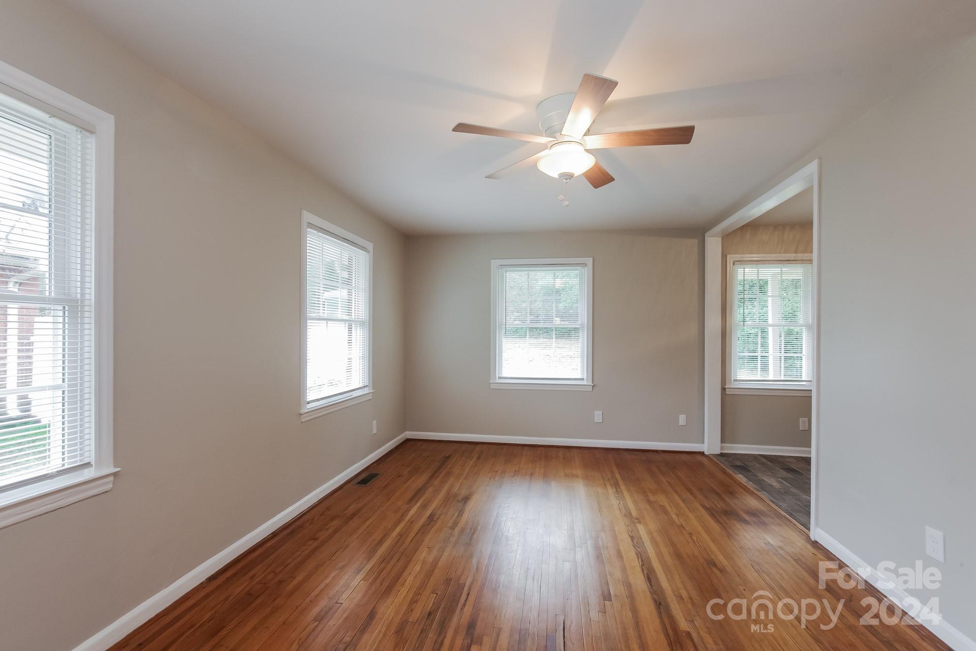 123 Boatright Road Pineville, NC 28134 - Photo 3 of 15 a view of an empty room with wooden floor and a window