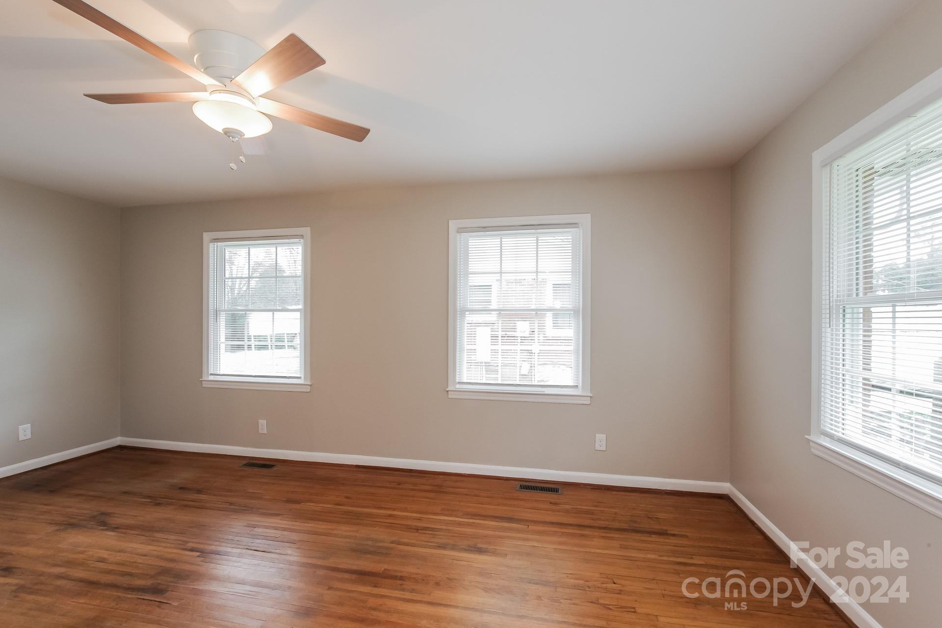 123 Boatright Road Pineville, NC 28134 - Photo 4 of 15 a view of an empty room with wooden floor and a window