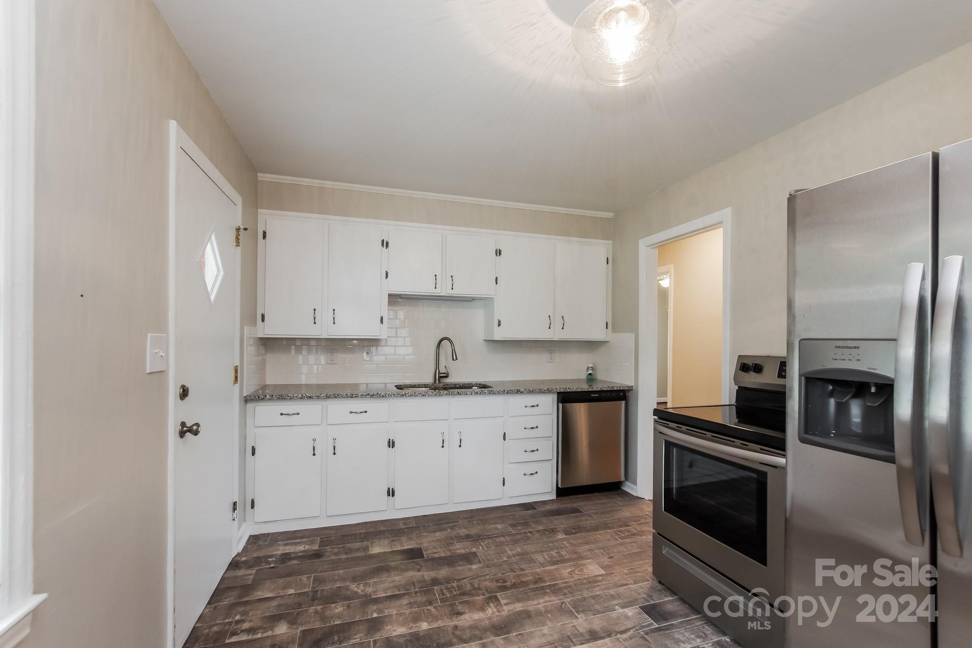 123 Boatright Road Pineville, NC 28134 - Photo 5 of 15 a kitchen with granite countertop white cabinets and stainless steel appliances