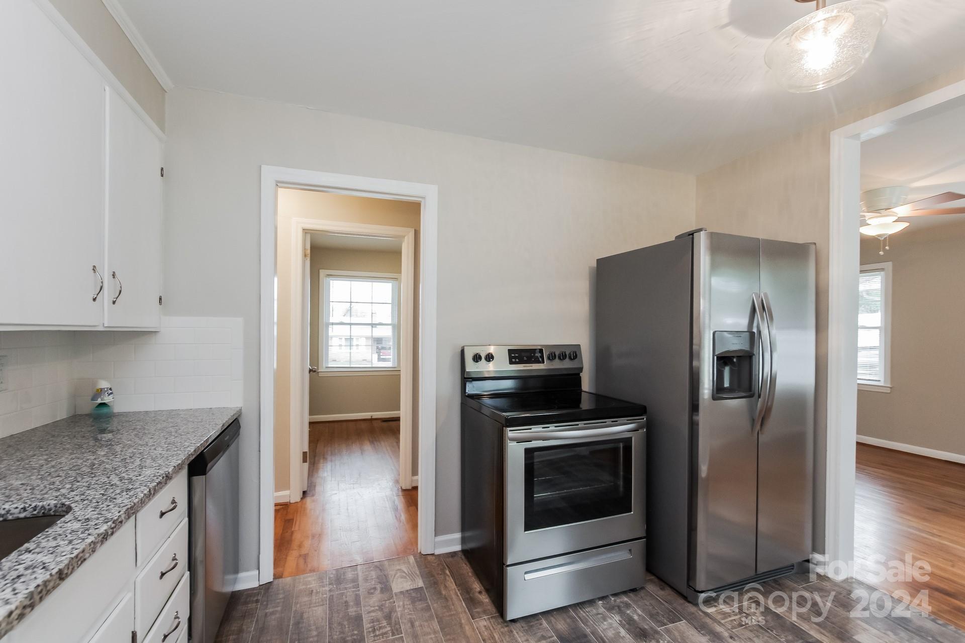 123 Boatright Road Pineville, NC 28134 - Photo 6 of 15 a kitchen with granite countertop a refrigerator and a stove top oven