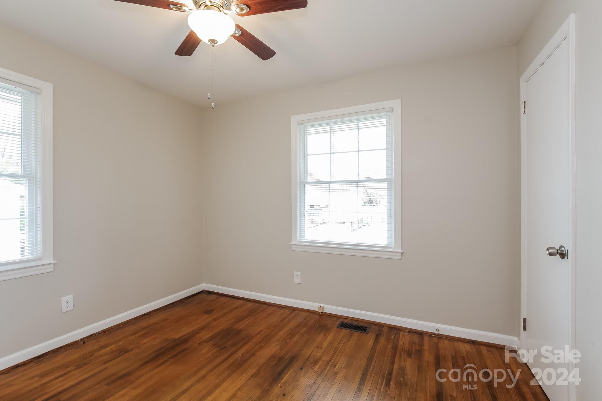 123 Boatright Road Pineville, NC 28134 - Photo 9 of 15 a view of an empty room with wooden floor and a window