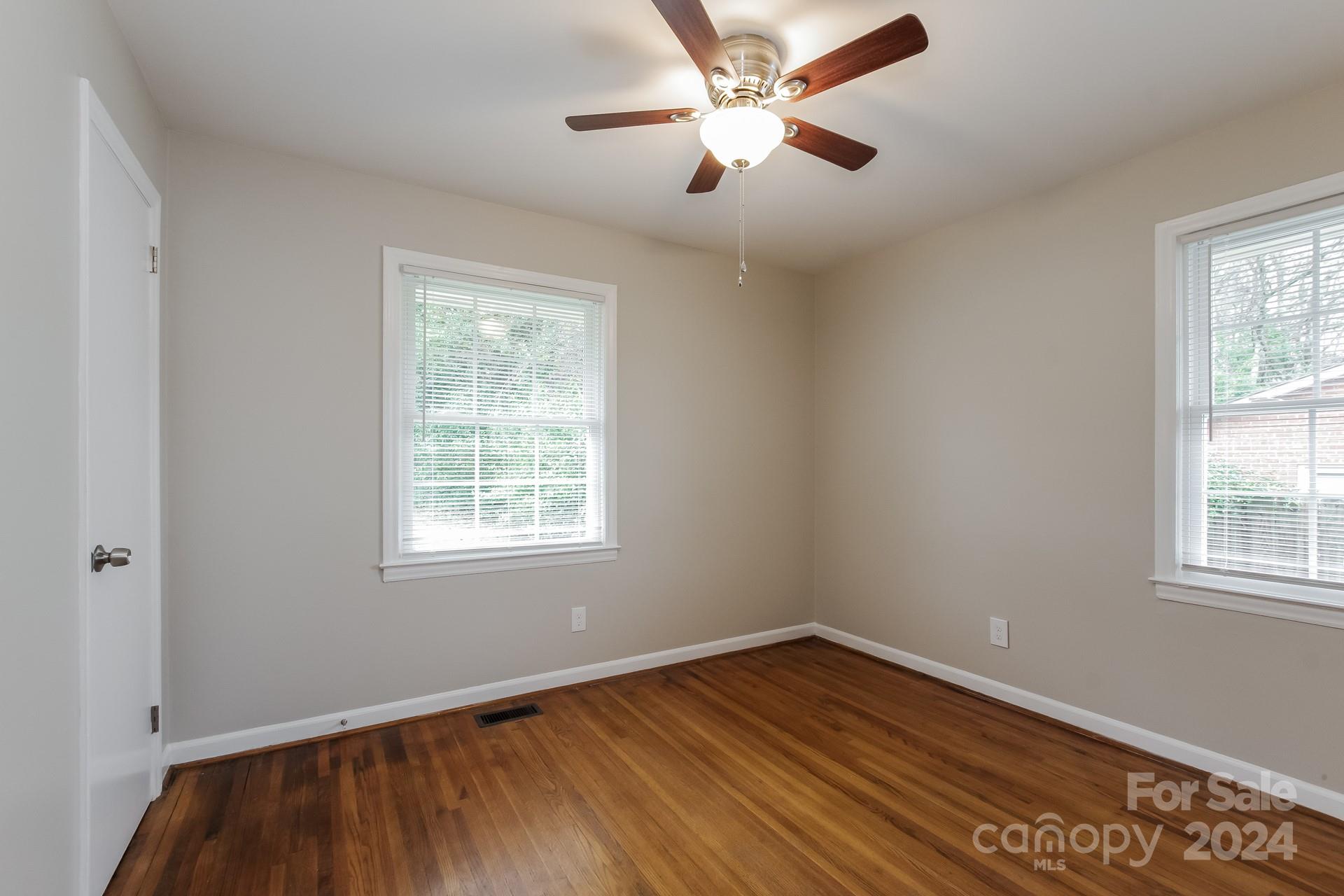 123 Boatright Road Pineville, NC 28134 - Photo 10 of 15 a view of empty room with wooden floor and fan