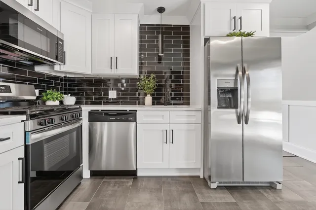 a kitchen with a sink a counter and cabinets
