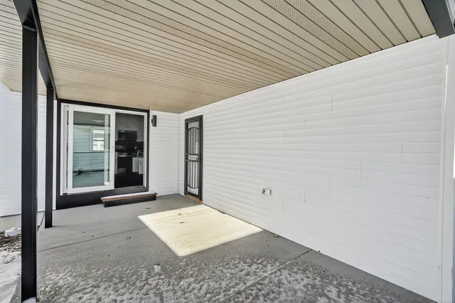 a view of a kitchen with furniture and stairs