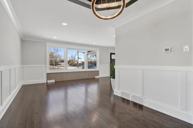 a view of a room with wooden floor and white walls