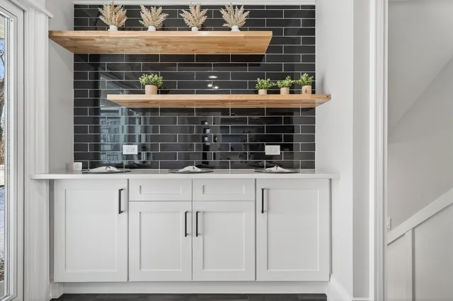 a kitchen with stainless steel appliances kitchen island granite countertop a refrigerator a stove and a sink with wooden floor