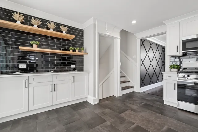 a bathroom with a sink a mirror a window and a shower