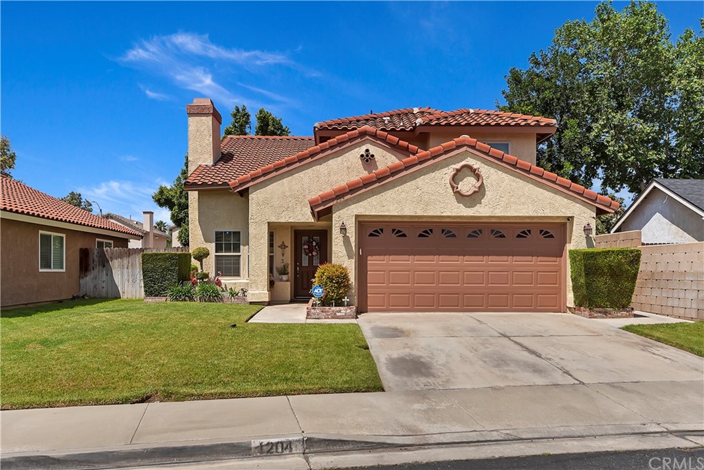 1204 South Yucca Avenue Rialto, CA 92376 - Photo 1 of 1 a front view of a house with a yard and garage