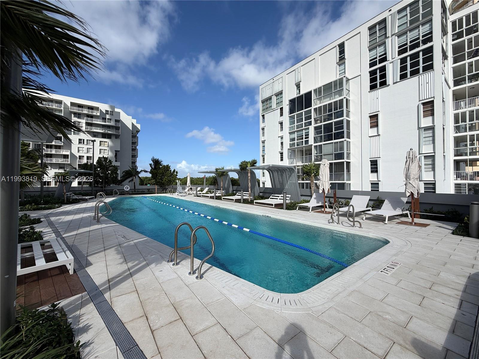 175 Southeast 25th Road, Unit 3102 Miami, FL 33129 - Photo 57 of 65 a view of a swimming pool with outdoor seating