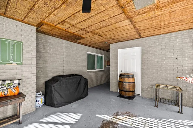 a backyard of a house with barbeque oven table and chairs