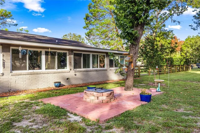 a front view of a house with garden and sitting area