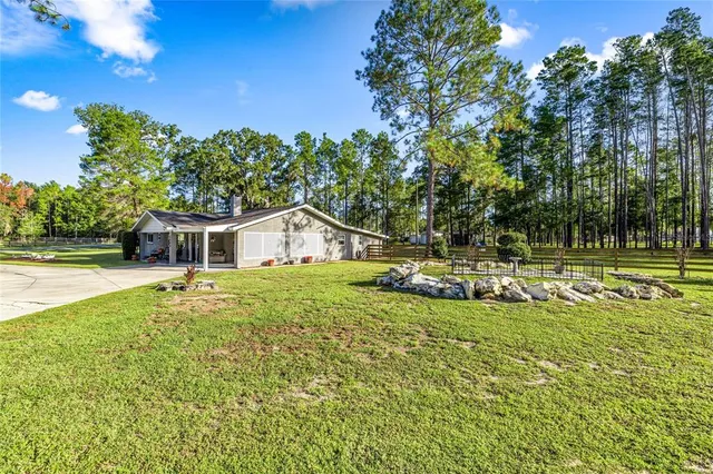 a view of a house with swimming pool and sitting area