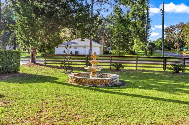 a front view of a house with a yard table and chairs