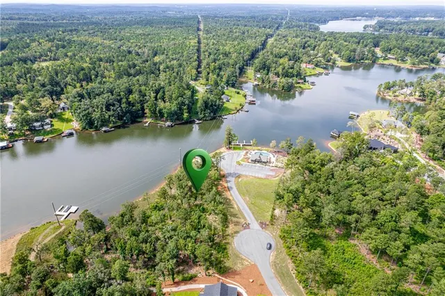 an aerial view of a house with a yard and lake view