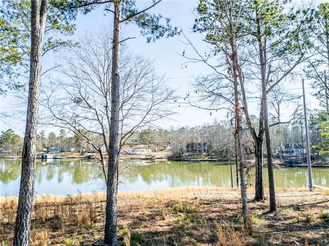 an aerial view of a house with a lake view