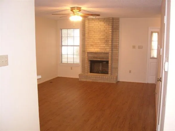 a view of staircase with wooden floor and white walls