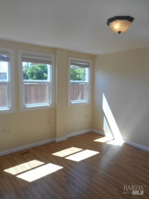 1020 Bennett Valley Road Santa Rosa, CA 95404 - Photo 12 of 24 an empty room with wooden floor and windows