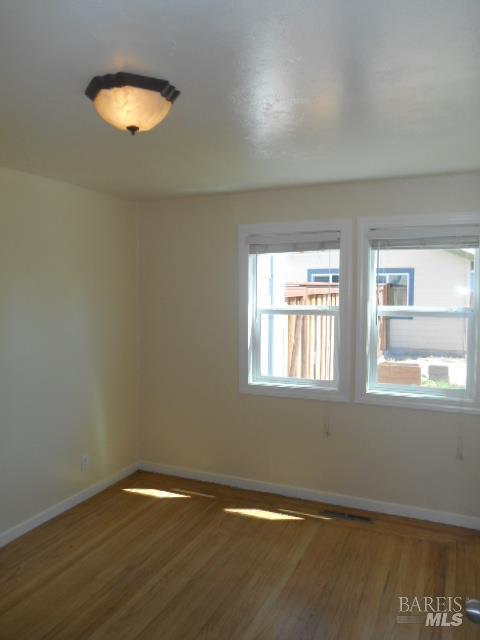 1020 Bennett Valley Road Santa Rosa, CA 95404 - Photo 13 of 24 an empty room with a window and wooden floor