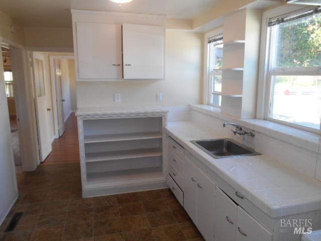 1020 Bennett Valley Road Santa Rosa, CA 95404 - Photo 14 of 24 a view of kitchen with granite countertop cabinets and a sink