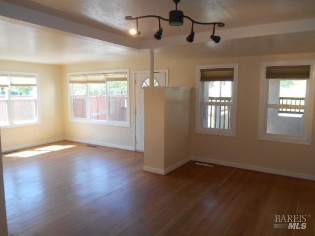 1020 Bennett Valley Road Santa Rosa, CA 95404 - Photo 16 of 24 a view of an empty room with wooden floor and a window