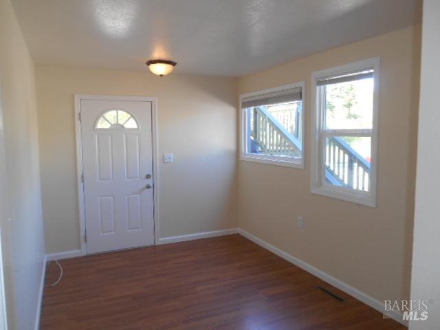 1020 Bennett Valley Road Santa Rosa, CA 95404 - Photo 8 of 24 an empty room with wooden floor and windows
