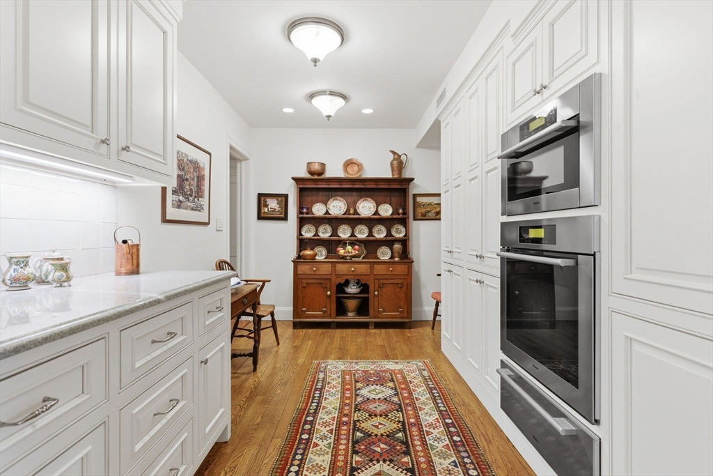 81 Beacon Street, Unit 8 Boston, MA 02108 - Photo 11 of 32 a kitchen with white cabinets and window
