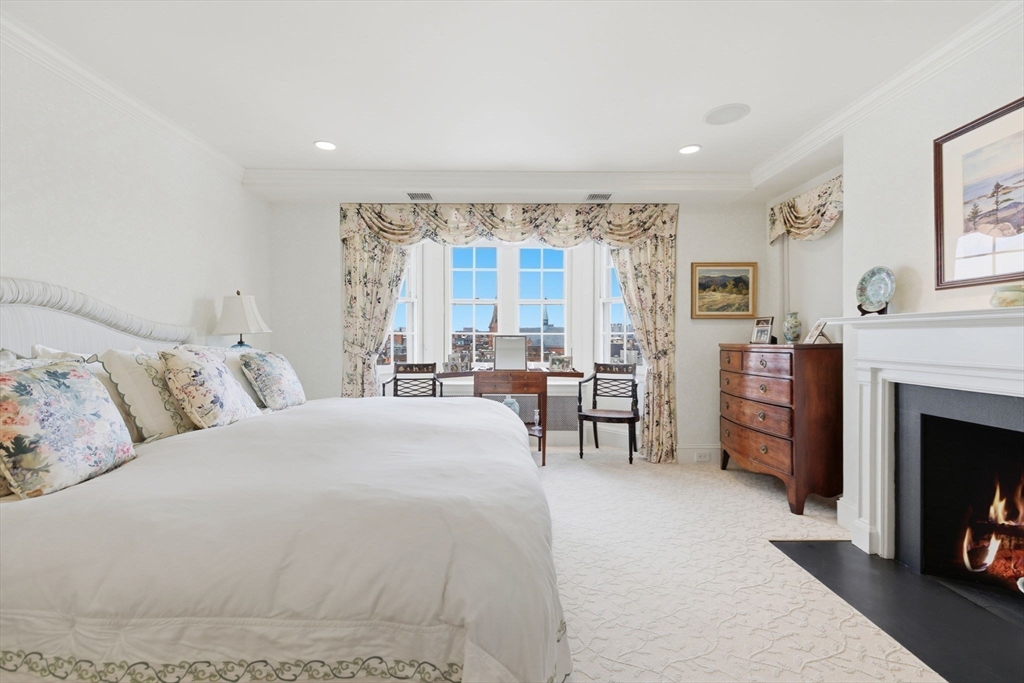 81 Beacon Street, Unit 8 Boston, MA 02108 - Photo 16 of 32 a spacious bedroom with a large bed and a fireplace