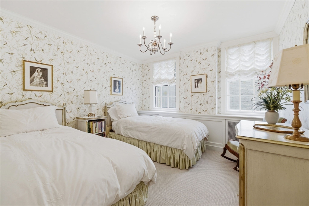 81 Beacon Street, Unit 8 Boston, MA 02108 - Photo 22 of 32 a spacious bedroom with two bed and a chandelier