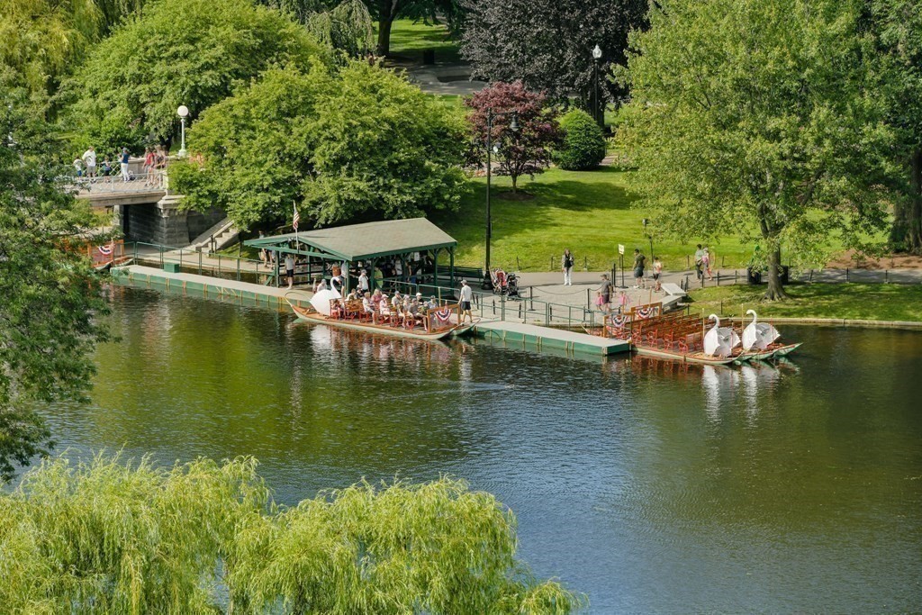 81 Beacon Street, Unit 8 Boston, MA 02108 - Photo 30 of 32 a view of a lake with lawn chairs under an umbrella