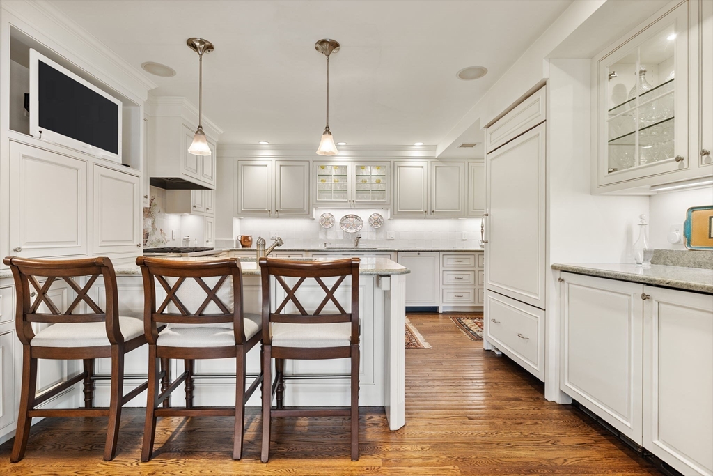 81 Beacon Street, Unit 8 Boston, MA 02108 - Photo 9 of 32 a kitchen with a table chairs stainless steel appliances and cabinets