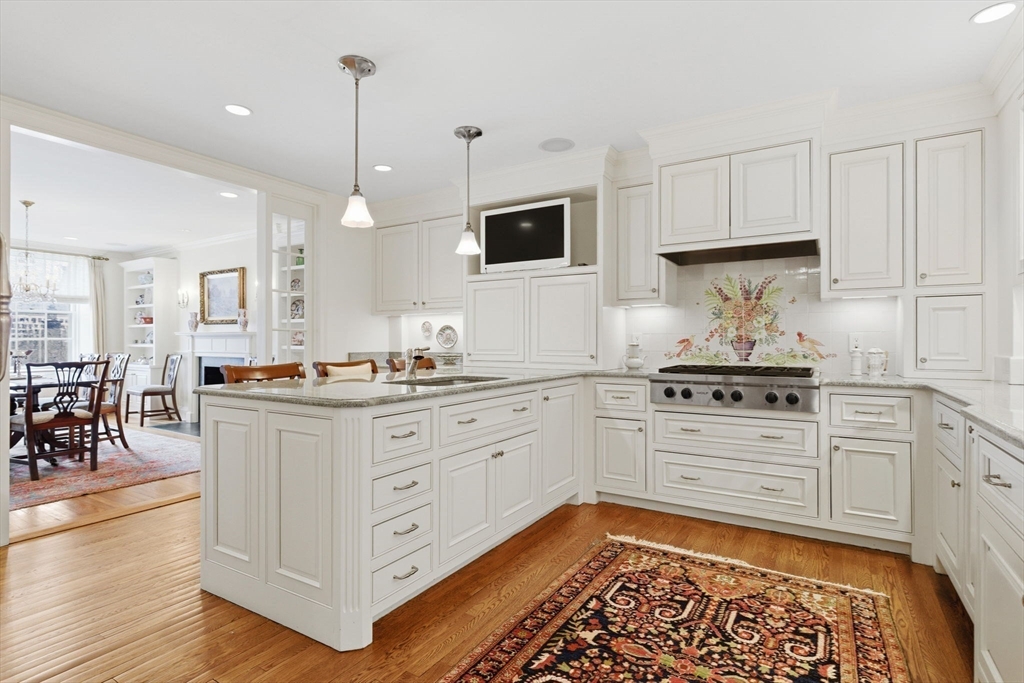 81 Beacon Street, Unit 8 Boston, MA 02108 - Photo 10 of 32 a kitchen with stainless steel appliances kitchen island granite countertop a stove a sink and a refrigerator