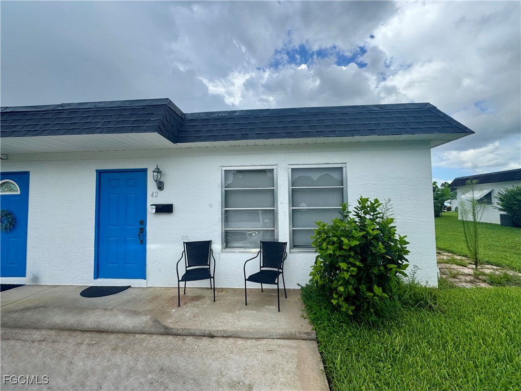 a view of a house with a porch and furniture