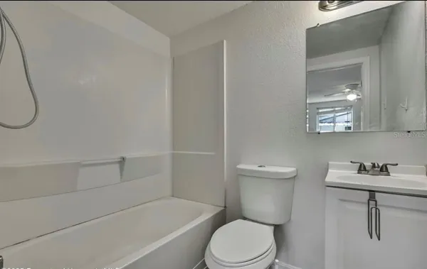 a bathroom with a toilet a sink and bathtub