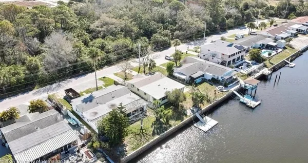 an aerial view of lake with residential houses with outdoor space