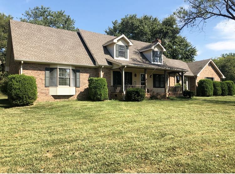 a front view of a house with a garden