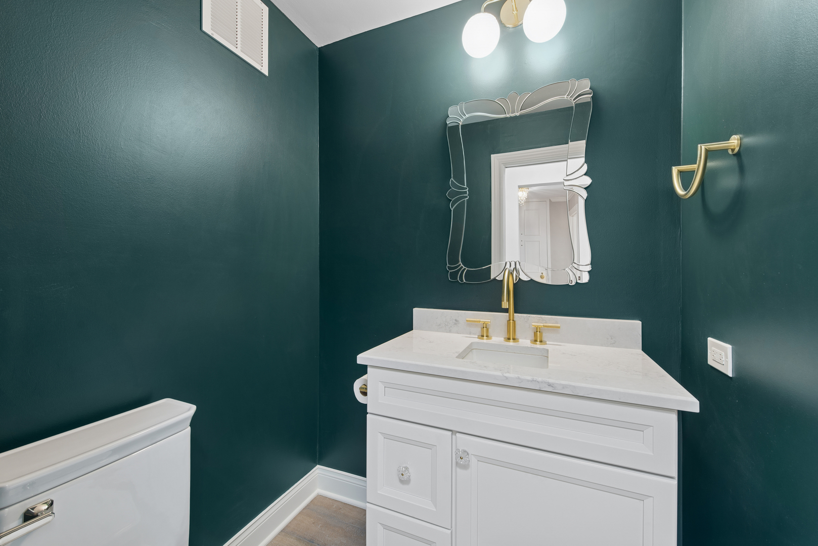 1500 Sheridan Road, Unit 1K Wilmette, IL 60091 - Photo 11 of 25 a bathroom with a toilet sink and mirror