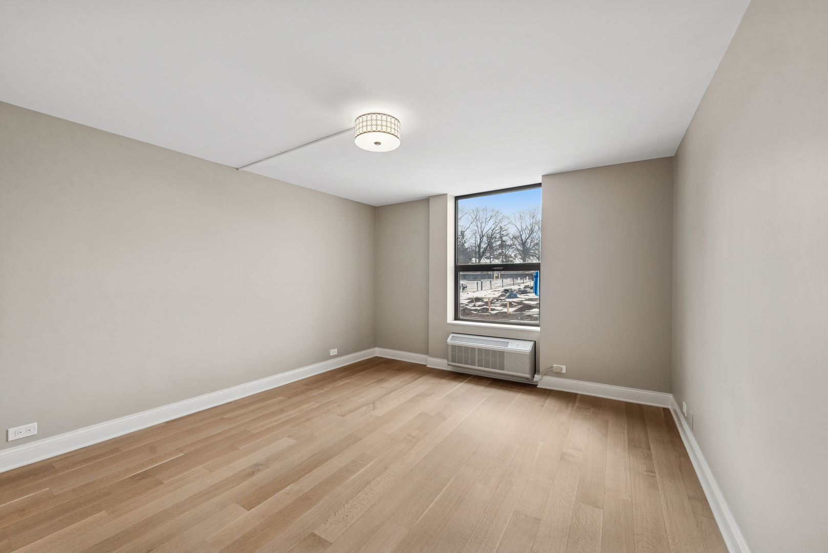 1500 Sheridan Road, Unit 1K Wilmette, IL 60091 - Photo 14 of 25 wooden floor in an empty room with a window