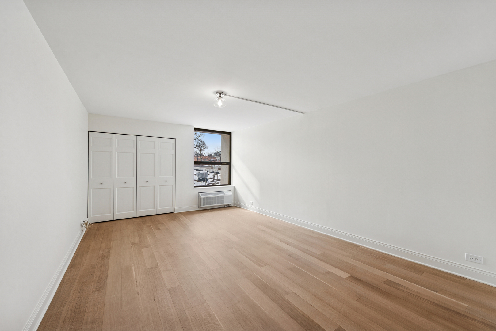1500 Sheridan Road, Unit 1K Wilmette, IL 60091 - Photo 15 of 25 an empty room with wooden floor closet and windows
