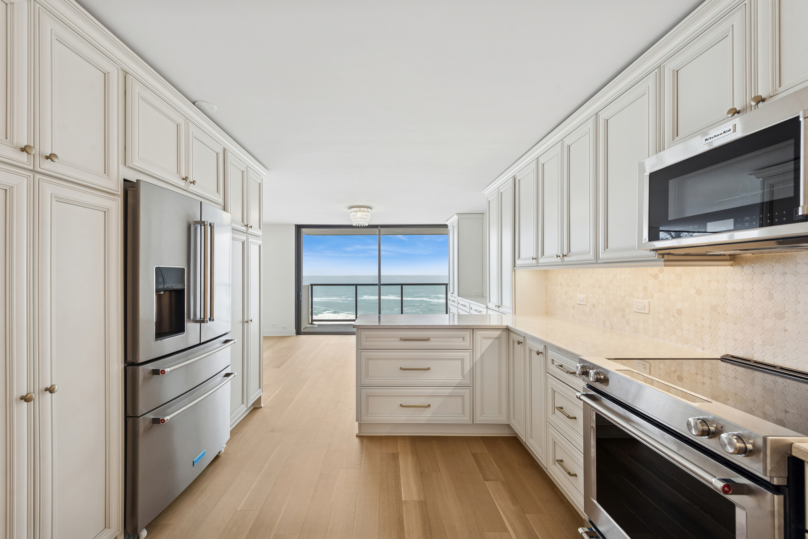 1500 Sheridan Road, Unit 1K Wilmette, IL 60091 - Photo 5 of 25 a kitchen with stainless steel appliances a stove microwave and cabinets