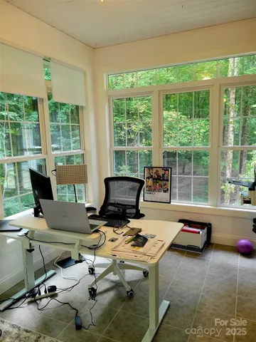 a work room with furniture and large windows
