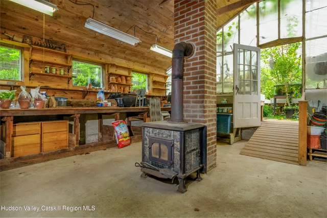 a kitchen with stainless steel appliances granite countertop a sink dishwasher a stove and a refrigerator with wooden floor