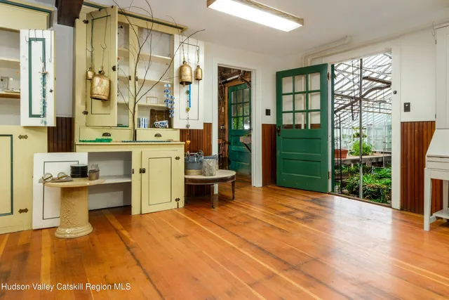 a backyard of a house with lots of green space and outdoor seating