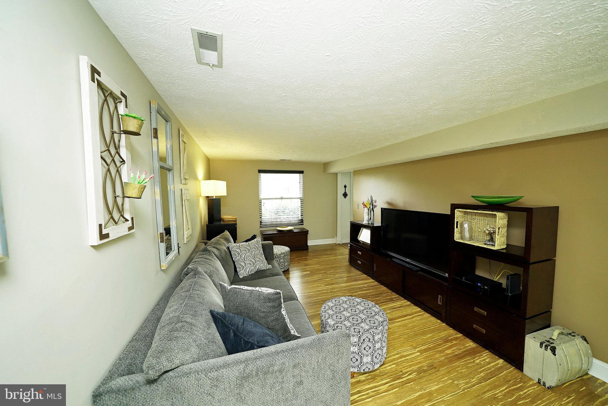 4424 Cub Run Road Chantilly, VA 20151 - Photo 11 of 30 a living room with furniture and a flat screen tv