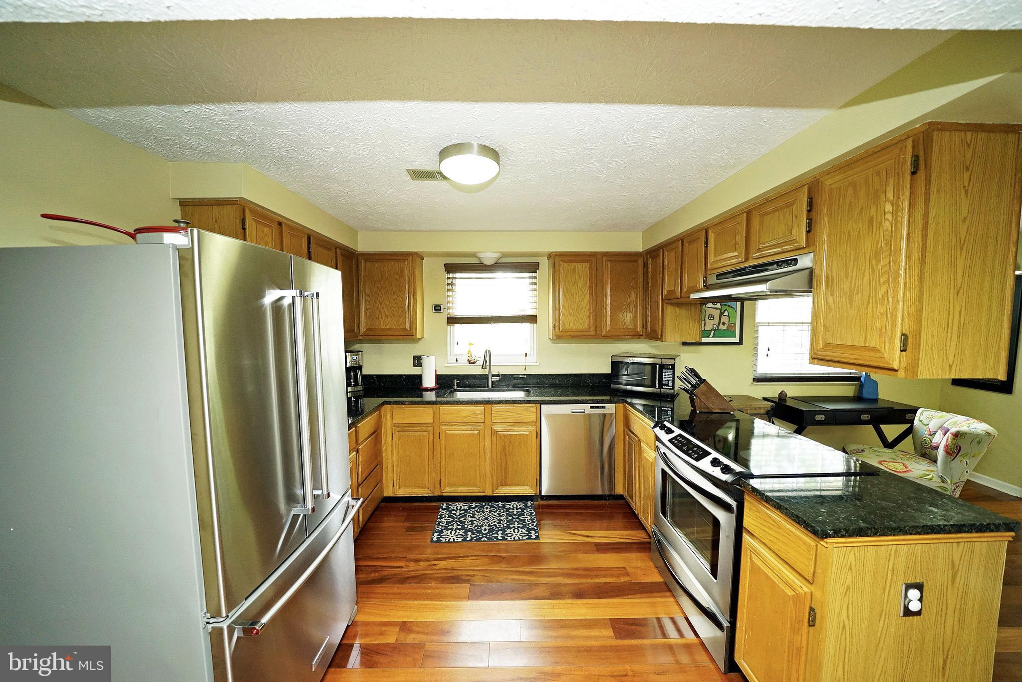 4424 Cub Run Road Chantilly, VA 20151 - Photo 12 of 30 a kitchen with stainless steel appliances granite countertop a refrigerator and a stove top oven