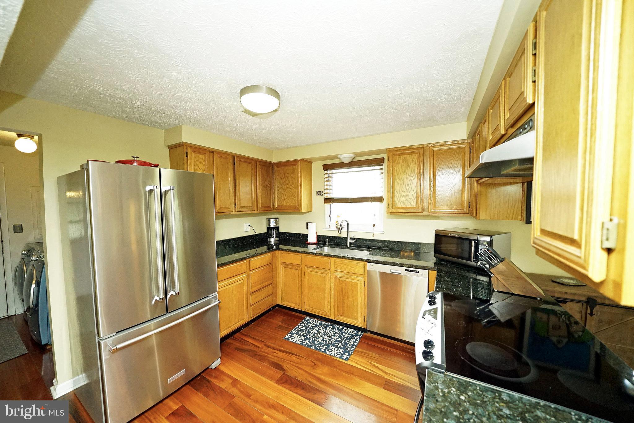 4424 Cub Run Road Chantilly, VA 20151 - Photo 13 of 30 a kitchen with stainless steel appliances granite countertop a refrigerator and a stove top oven